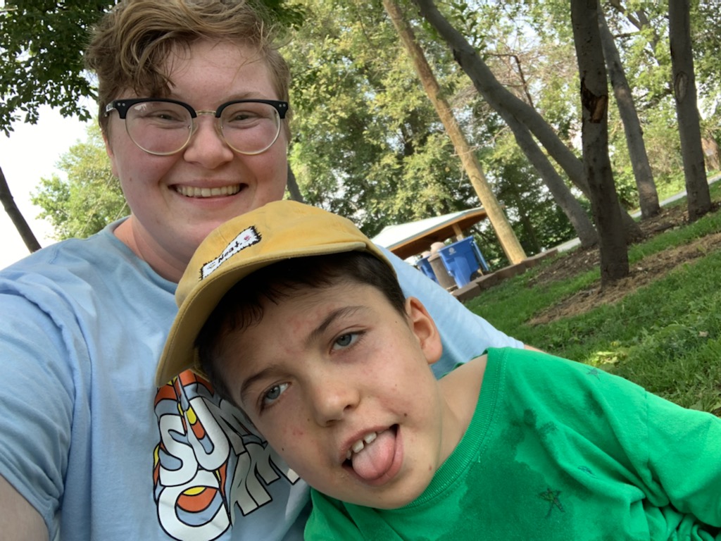 Staff Member Alex has fun with a participant at summer camp.